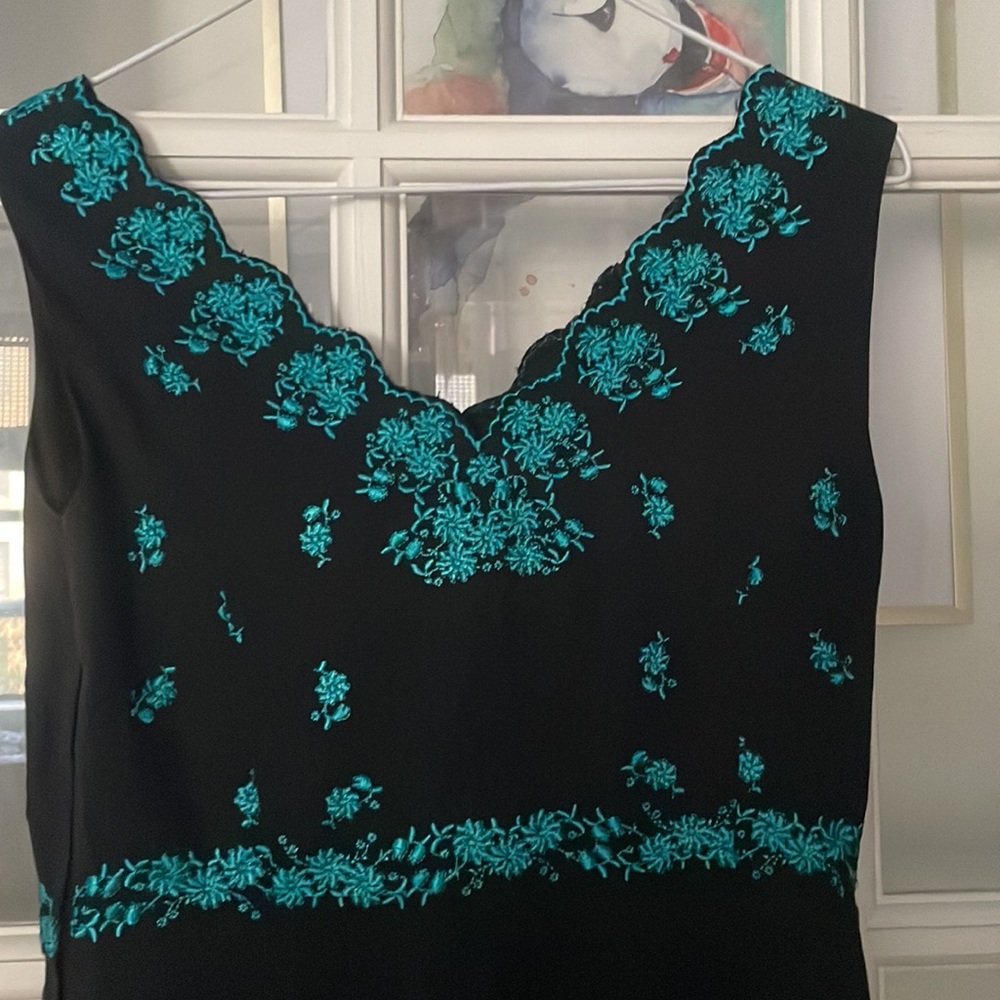 Summer-perfect dress with aqua floral embroidery details.No size tag, fits XS